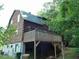 View of the home with a walkout deck and a ground-level basement at 207 High House Rd, Cary, NC 27513