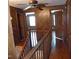 View of the wooden-paneled hallway and staircase showcasing the rustic charm of the log home at 207 High House Rd, Cary, NC 27513