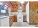 Functional kitchen featuring light countertops, white appliances, and warm wood cabinetry for storage at 207 High House Rd, Cary, NC 27513