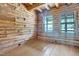 Bright and airy living room, featuring log walls, hardwood floors, and large windows with natural light at 207 High House Rd, Cary, NC 27513