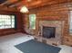 Cozy living room featuring log walls, fireplace, and windows with natural light at 207 High House Rd, Cary, NC 27513