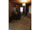 Cozy living room with wood paneling, a comfortable couch, and a decorative chandelier, perfect for relaxing at 207 High House Rd, Cary, NC 27513