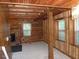 Interior view with log walls and exposed beams leading to a room with windows at 207 High House Rd, Cary, NC 27513
