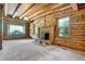 Log cabin living room featuring a fireplace and large windows offering natural light at 207 High House Rd, Cary, NC 27513