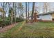 Large backyard featuring mature trees and lush lawn at 209 High House Rd, Cary, NC 27513