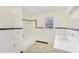 Bathroom with tiled floors and walls, a sink, a tub, and a shower combination at 209 High House Rd, Cary, NC 27513