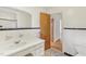 Well-lit bathroom features a vanity with storage and classic black and white tile at 209 High House Rd, Cary, NC 27513