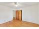 Bright bedroom features hardwood floors, a ceiling fan and a closet with wooden doors at 209 High House Rd, Cary, NC 27513