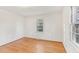 Bright bedroom features hardwood floors and large window providing plenty of natural light at 209 High House Rd, Cary, NC 27513