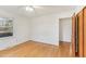 Bright bedroom features hardwood floors, a ceiling fan and a closet with wooden doors at 209 High House Rd, Cary, NC 27513
