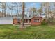Classic single-story brick home featuring a cozy front porch and lush green lawn at 209 High House Rd, Cary, NC 27513