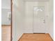 Bright entryway with hardwood floors, a white front door with half-moon glass, and crisp white walls at 209 High House Rd, Cary, NC 27513