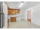 Spacious kitchen with wood cabinets, white appliances, and geometric flooring at 209 High House Rd, Cary, NC 27513