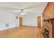 Cozy living room features a ceiling fan, wood paneling, and brick fireplace at 209 High House Rd, Cary, NC 27513