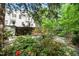 Lush backyard featuring a stone wall, manicured plants and shrubs, creating a serene oasis and enhancing privacy at 2105 White Oak Rd, Raleigh, NC 27608