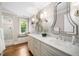 Bathroom with a double vanity, marble countertops, large mirrors, and a glass-enclosed shower at 2105 White Oak Rd, Raleigh, NC 27608
