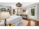 Bedroom with a ceiling fan and natural light, wooden desk, and a door to the outside at 2105 White Oak Rd, Raleigh, NC 27608