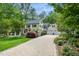 A long cobblestone driveway leads to this grand home with black shutters and manicured landscaping at 2105 White Oak Rd, Raleigh, NC 27608