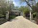 Charming estate featuring a brick driveway and a welcoming entrance gate at 2105 White Oak Rd, Raleigh, NC 27608