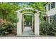A beautiful wrought-iron gate and trellis enhance this home's manicured front yard at 2105 White Oak Rd, Raleigh, NC 27608