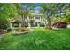 Well-manicured lawn with beautiful landscaping and mature trees in front of the two-story home at 2105 White Oak Rd, Raleigh, NC 27608