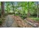 Peaceful stone pathway winds through lush greenery, offering a serene escape amidst nature's beauty and tranquility at 2105 White Oak Rd, Raleigh, NC 27608