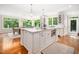 Open concept kitchen with white cabinetry, a center island, and hardwood floors at 2105 White Oak Rd, Raleigh, NC 27608