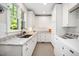 Well-lit laundry room with white cabinets, granite countertops, and modern washer and dryer at 2105 White Oak Rd, Raleigh, NC 27608