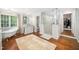 Bright main bathroom with walk-in glass shower, free standing tub, large mirrors and wood floors at 2105 White Oak Rd, Raleigh, NC 27608