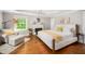 Comfortable main bedroom with a fireplace, large window, and a cozy sitting area at 2105 White Oak Rd, Raleigh, NC 27608