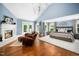 A comfortable main bedroom with high ceilings, chandelier, seating area, a fireplace, and a large area rug at 2105 White Oak Rd, Raleigh, NC 27608