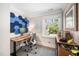 Office space with an adjustable desk, ergonomic chair, and a window providing natural light at 2105 White Oak Rd, Raleigh, NC 27608