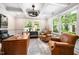 Bright home office with coffered ceilings, large windows, and leather chairs at 2105 White Oak Rd, Raleigh, NC 27608