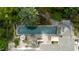 Aerial view of a large rectangular pool with seating and a pergola surrounded by lush greenery at 2105 White Oak Rd, Raleigh, NC 27608