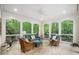 Covered porch with wicker furniture, a ceiling fan, and views of the surrounding greenery at 2105 White Oak Rd, Raleigh, NC 27608