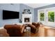 Comfortable sitting area featuring leather chairs, a fireplace, and access to an outdoor area at 2105 White Oak Rd, Raleigh, NC 27608