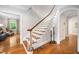 Staircase with hardwood steps and white risers, leading to the upper level of the home at 2105 White Oak Rd, Raleigh, NC 27608