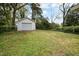 View of a detached garage, surrounded by a lush backyard and mature trees at 2106 Ruffin St, Durham, NC 27704