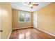 Bedroom features wood floors, a ceiling fan, and a bright window view at 2106 Ruffin St, Durham, NC 27704