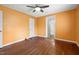 Cozy room with wood floor, ceiling fan, and a door leading to another room at 2106 Ruffin St, Durham, NC 27704