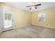 Bright bedroom with carpeted floor, ceiling fan, and a door leading to the outside at 2106 Ruffin St, Durham, NC 27704