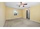 Bedroom featuring carpeted floor, ceiling fan, and a bright window view at 2106 Ruffin St, Durham, NC 27704