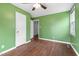 This is a cozy bedroom with dark wood floors and a ceiling fan at 2106 Ruffin St, Durham, NC 27704