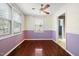A dining room with hardwood floors, neutral paint colors, wainscoting and a ceiling fan with a light at 2106 Ruffin St, Durham, NC 27704