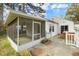 Wide exterior shot of a screened porch and deck, as well as a view of the lush backyard at 2106 Ruffin St, Durham, NC 27704