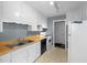 The kitchen contains white cabinets, gray walls, wood counters, an electric range, and black appliances at 2106 Ruffin St, Durham, NC 27704