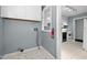 The laundry area leads into the kitchen and contains upper cabinets and all the necessary hookups at 2106 Ruffin St, Durham, NC 27704