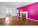 Spacious living room with hardwood floors, fireplace, and bright accent wall at 2106 Ruffin St, Durham, NC 27704