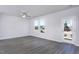 Bright living room with wood floors, ceiling fan, and back door leading to the back yard at 2112 Willow Gln Dr, Graham, NC 27253