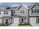 Charming townhome featuring a stone and shingle facade, attached garages, and neatly landscaped front yards at 2118 Willow Gln Dr, Graham, NC 27253
